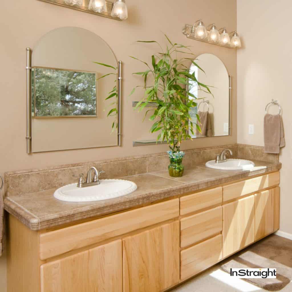 sleek framed mirrors on top of a wooden vaniity